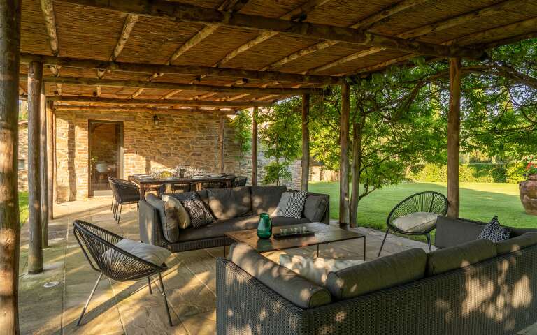 covered al fresco dining surrounded by majestic garden